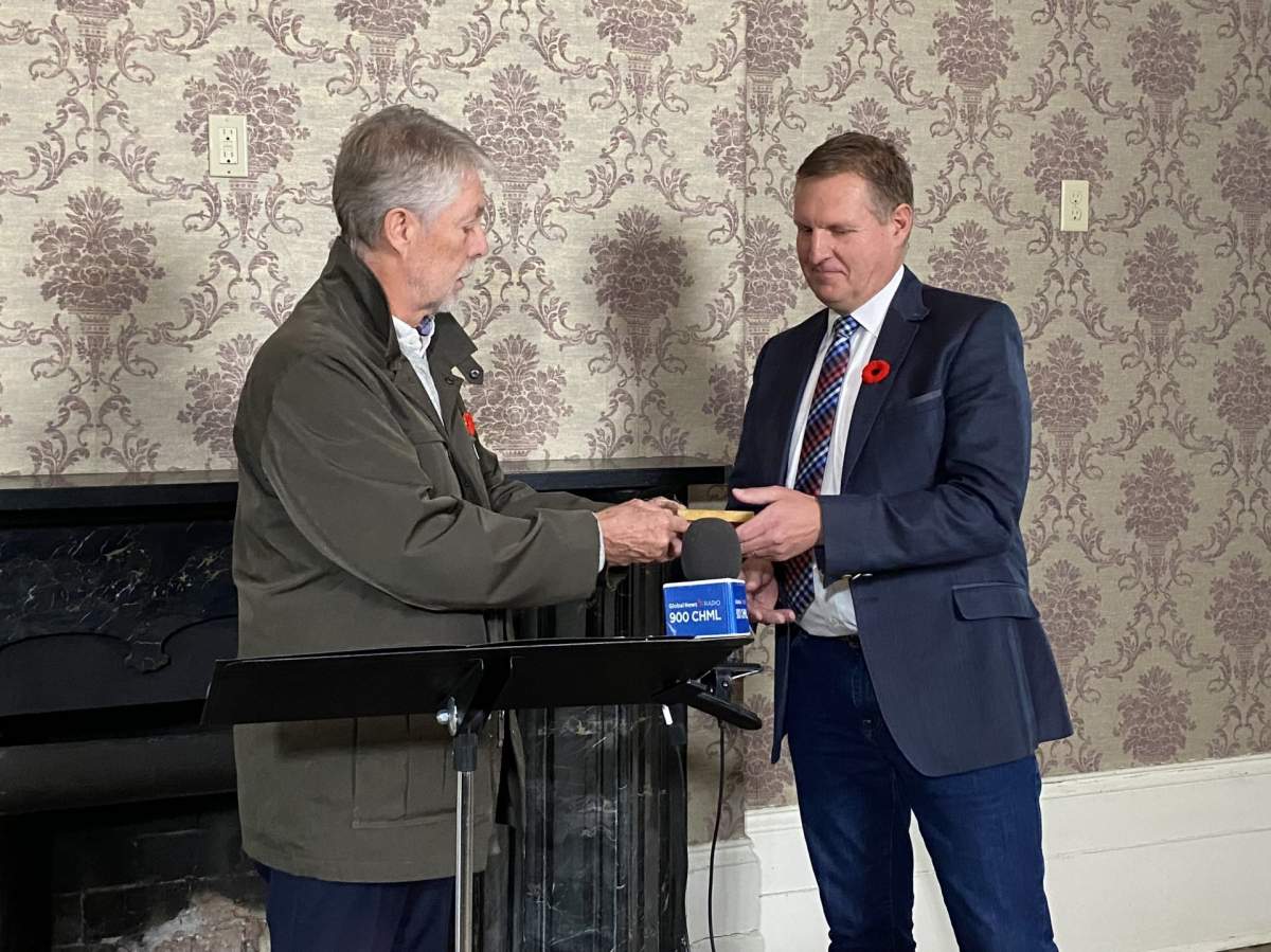 Outgoing Hamilton mayor Fred Eisenberger hands over the keys to Chedoke Estate to Michael Van Pelt, CEO and President of Cardus.