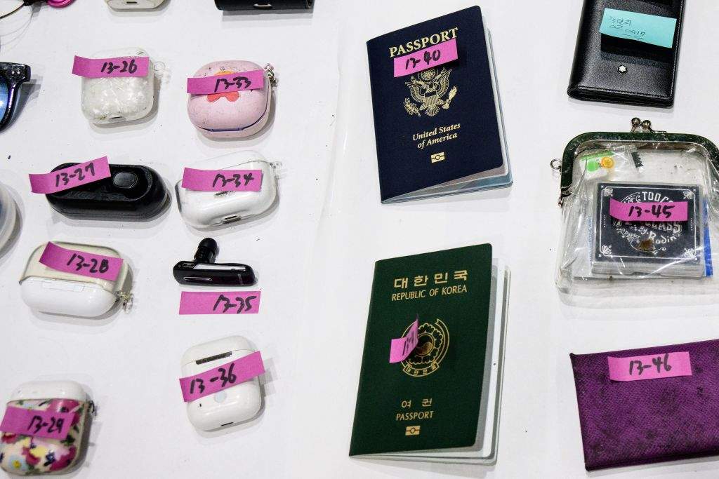 Personal belongings, including a US (top) and South Korean passport retrieved by police.