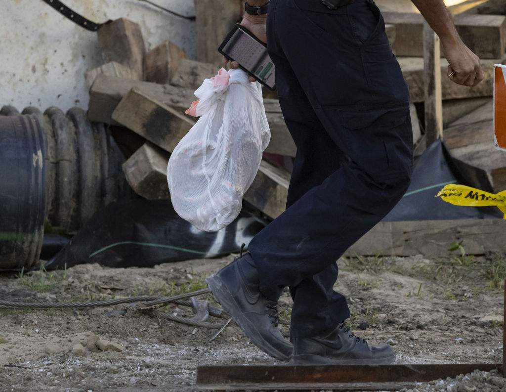 A Chicago police officer carries a bag containing rope from the construction site of the Obama Presidential Center on Thursday, Nov. 10, 2022.