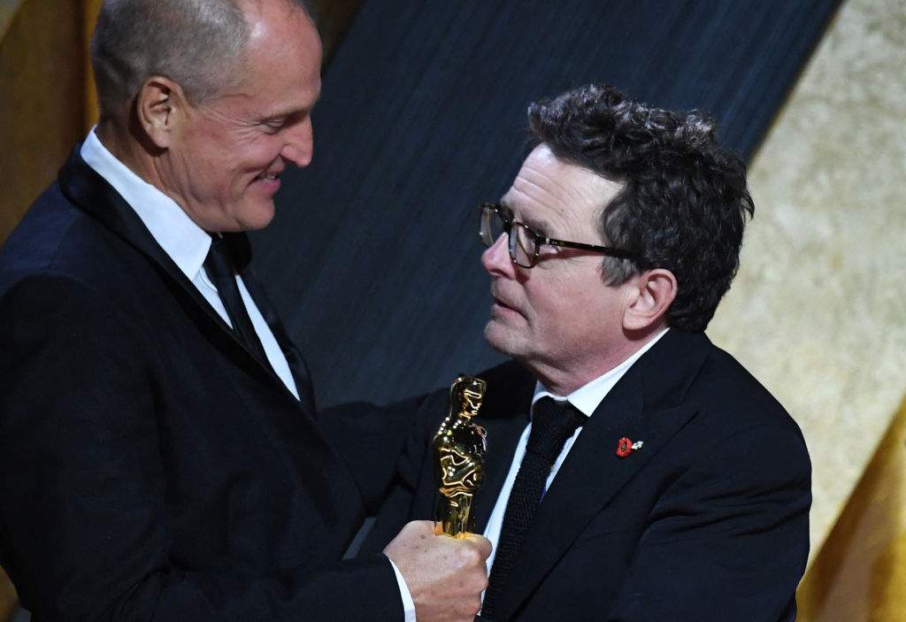 Honoree Canadian-American actor Michael J. Fox (R) accepts the Jean Hersholt Humanitarian Award from U.S. actor Woody Harrelson during the Academy of Motion Picture Arts and Sciences’ 13th Annual Governors Awards at the Fairmont Century Plaza in Los Angeles on Nov. 19, 2022.