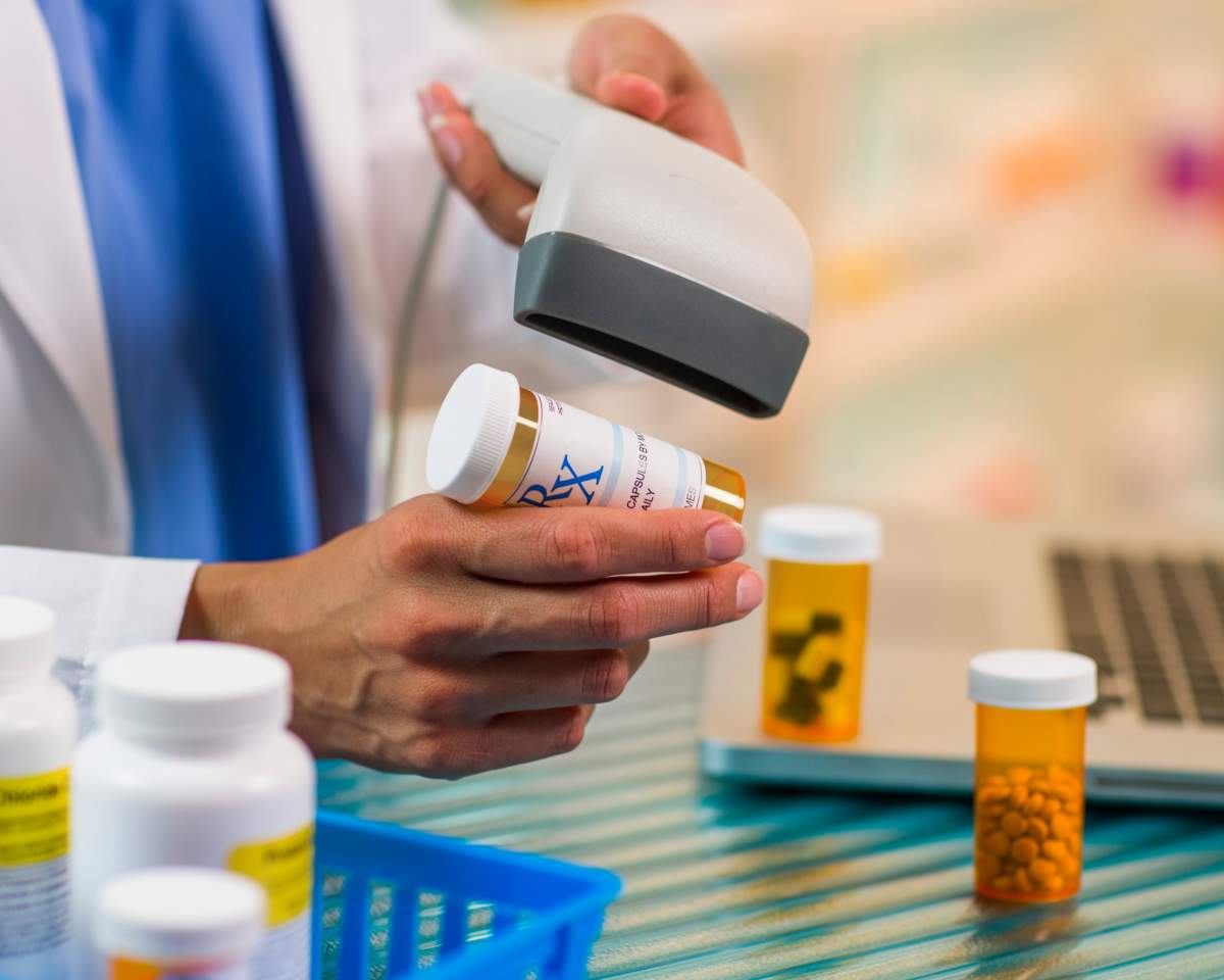 File - Closeup of a pharmacist scanning a prescription.