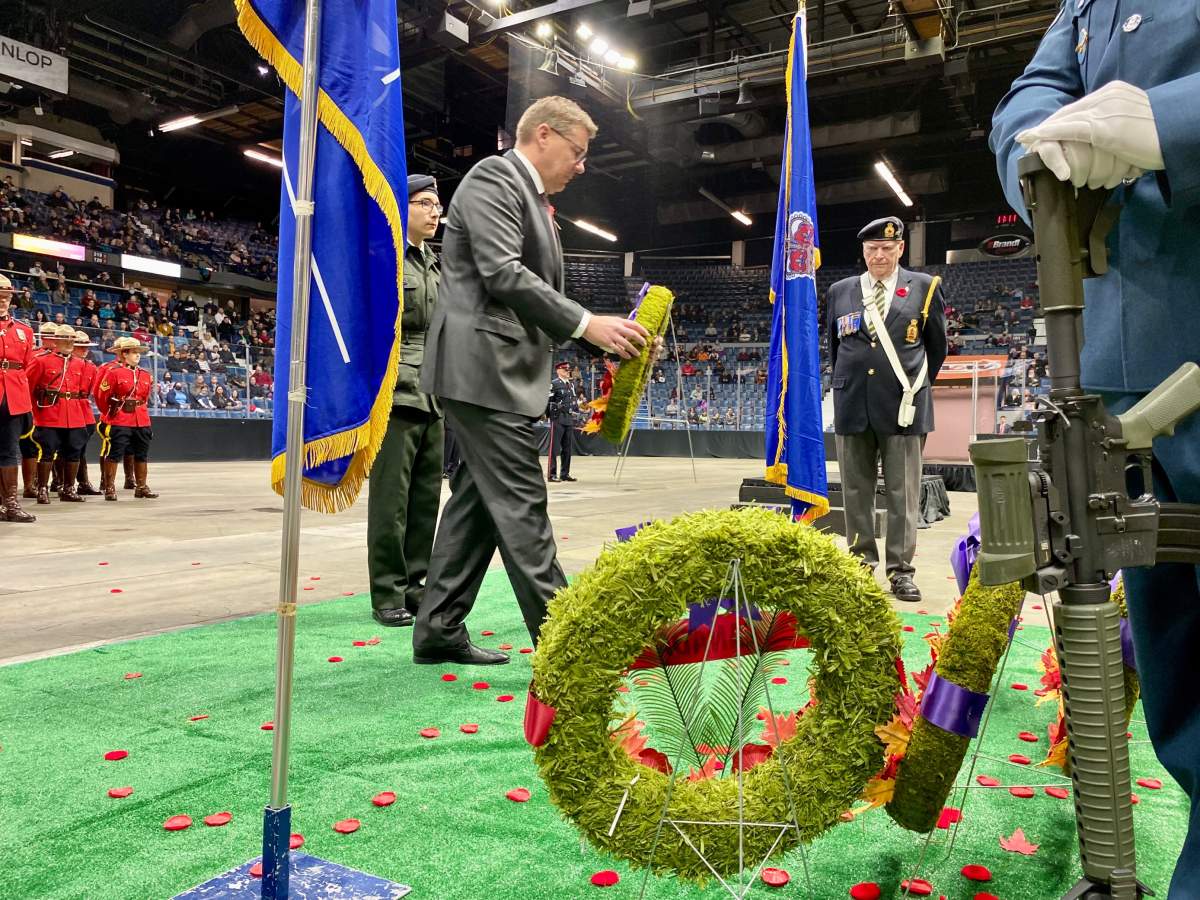 Saskatchewan Premier Scott Moe can be seen placing a wreath during Regina’s Remembrance Day ceremony.