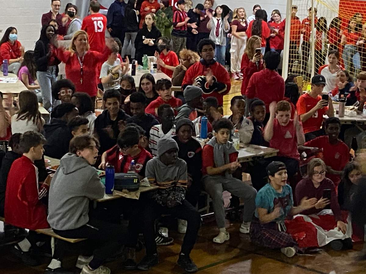 At St. Nicholas Catholic Junior High in Edmonton, where Davies attended and played in the school's soccer academy, students filled a gym where the Canadian star used to play to cheer on their favourite alumnus.