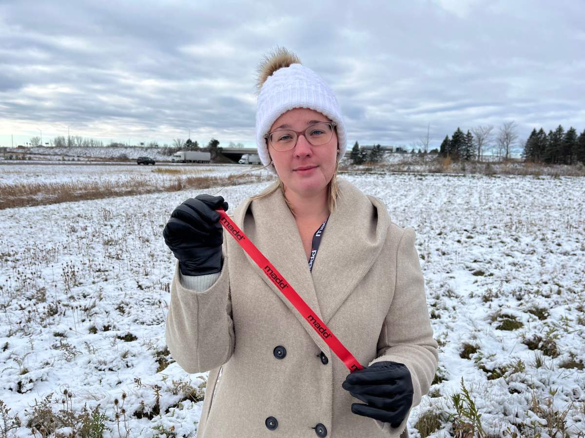 MADD London president Sara Neusteter holds a red ribbon, which drivers can hang on their rearview mirror this holiday season to show they’re committed to driving sober.