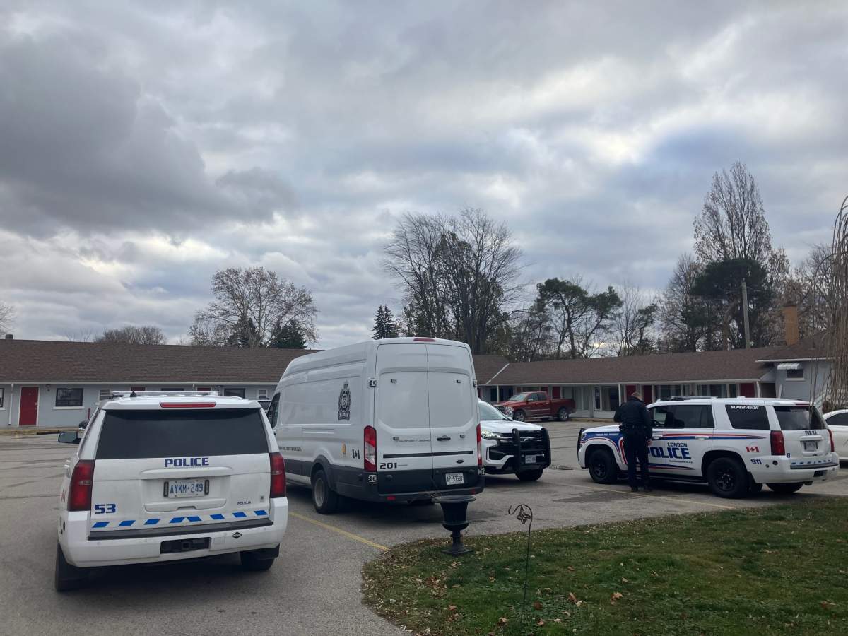 London Police Service vehicles sit parked inside the American Plaza Motel parking lot as officers investigate a report of a possible shooting in the area.