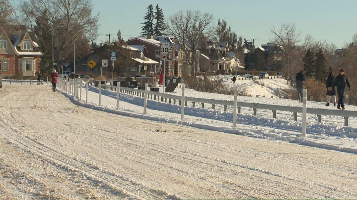 Pedestrians walk along paths beside Calgary's Crescent Road N.W. on Nov. 11, 2022.