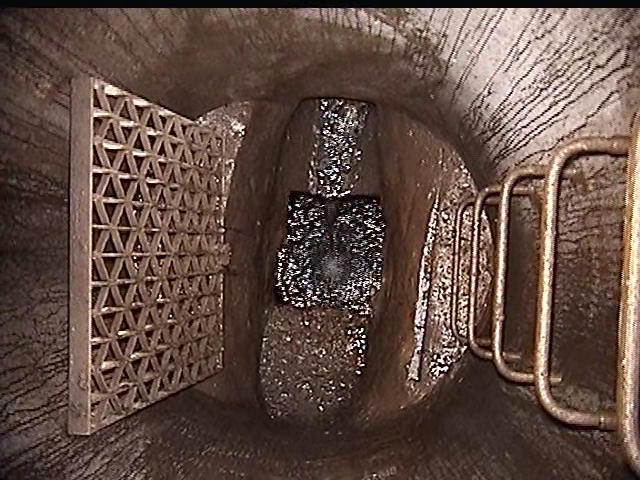 A screenshot captured by city staff in November 2022 from a 2013 video showcasing an aerial image looking down at the cross connection where the combined sewer water is incorrectly entering the storm sewer below it.