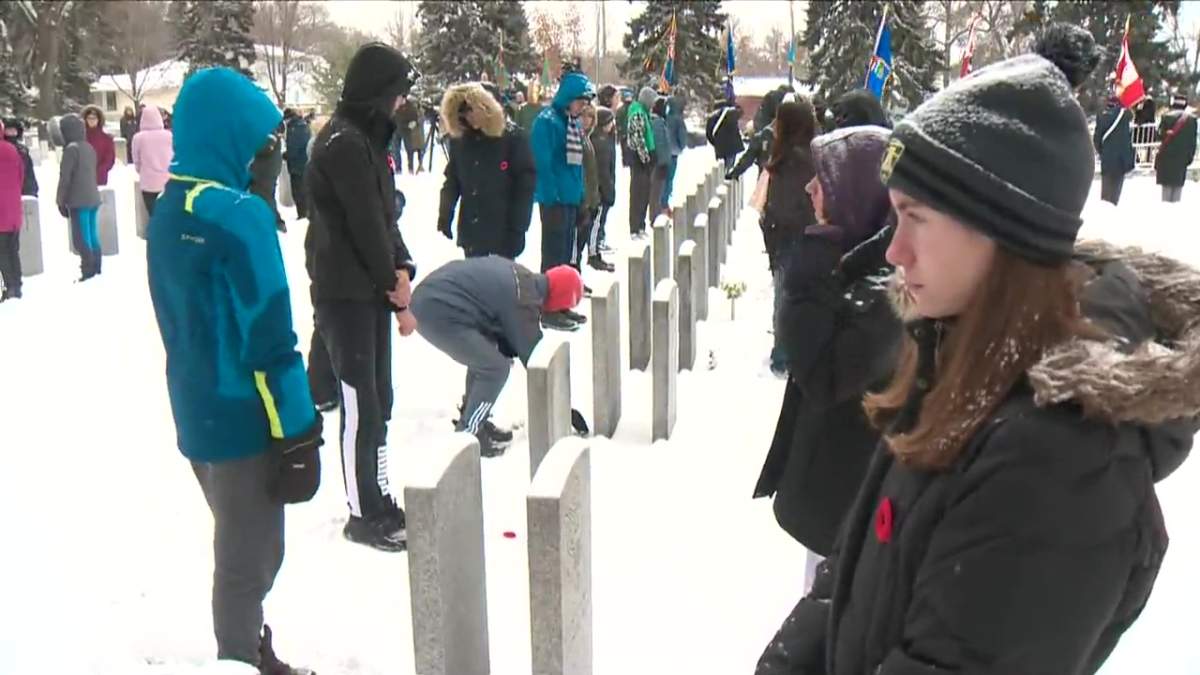 Poppies being placed at a No Stone Left Alone remembrance ceremony at Beechmount Cemetery in Edmonton, Alta. on Monday, Nov. 7, 2022.