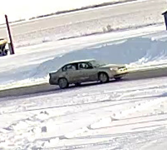 A light-coloured 4-door sedan, believed to be between the years of 2004-2008.