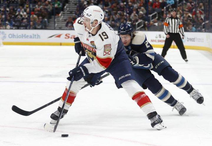 Florida Panthers forward Matthew Tkachuk, left, controls the puck in front of Columbus Blue Jackets defenceman Andrew Peeke during the first period an NHL hockey game in Columbus, Ohio, Sunday, Nov. 20, 2022.