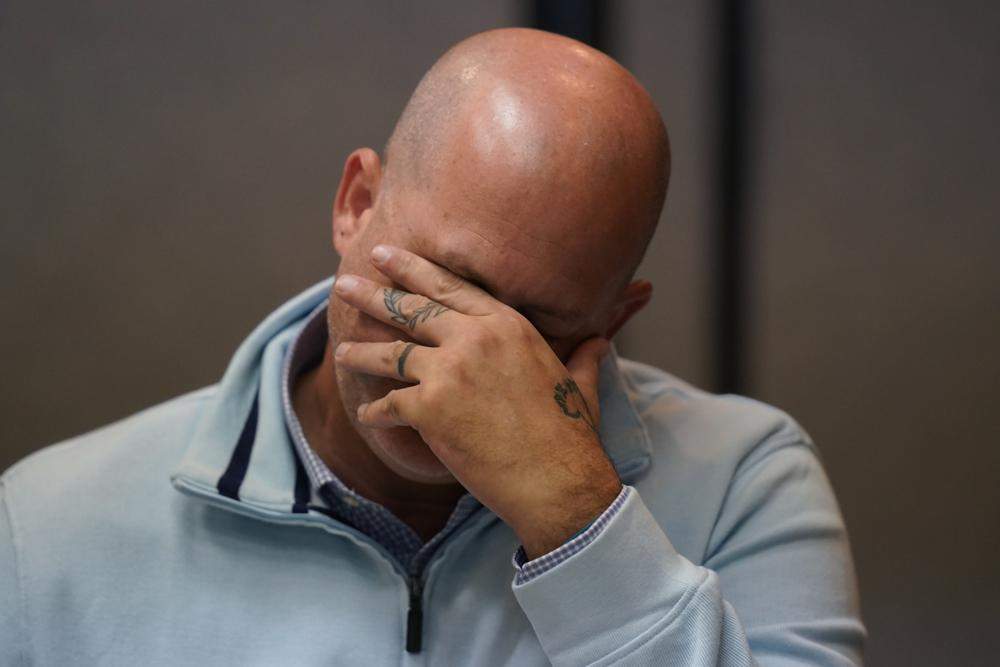 Joseph Petito holds his head in one hand.