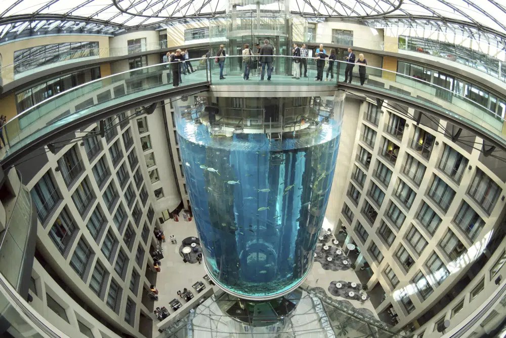 People gather on the top of the AquaDom aquarium at the Sea Life tourist attraction in Berlin.