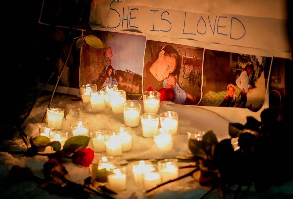 A vigil with photos of Morgan Harris attached is shown as family and friends of three murdered women gather at a vigil in Winnipeg.