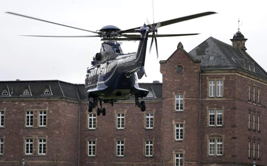 A police helicopter with a suspect arrives in Karlsruhe, Germany, Wednesday, Dec. 7, 2022 close the federal prosecutor’s office. Thousands of police officers carried out raids across much of Germany on Wednesday against suspected far-right extremists who allegedly sought to overthrow the government in an armed coup. Officials said 25 people were detained.