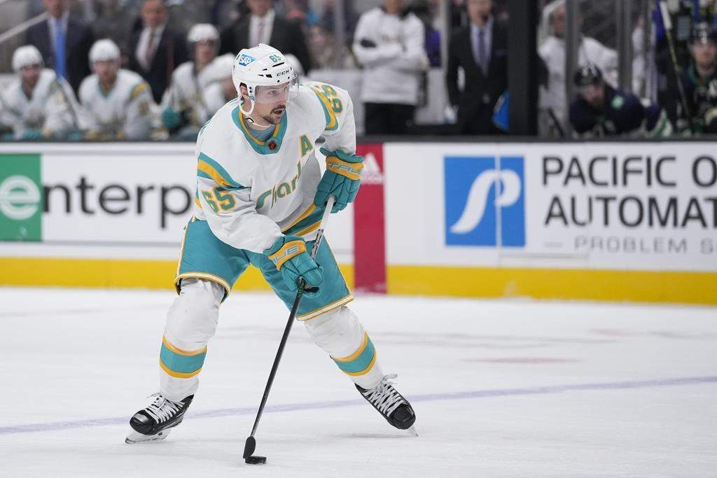San Jose Sharks defenceman Erik Karlsson prepares to shoot against the Vancouver Canucks during the first period of an NHL hockey game in San Jose, Calif., Wednesday, Dec. 7, 2022.