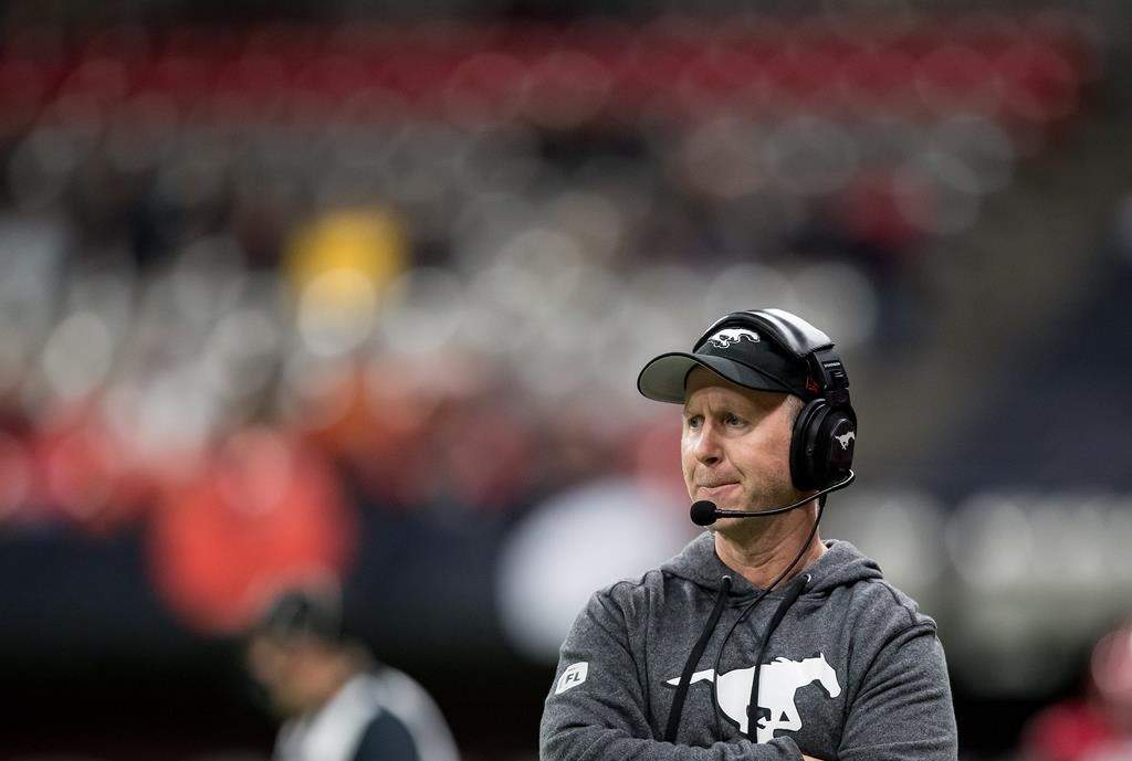 Calgary Stampeders head coach Dave Dickenson stands on the sideline during the first half of a CFL football game against the B.C. Lions in Vancouver, on Friday, November 12, 2021. Dickenson is taking over as general manager, while John Hufnagel will continue as team president.