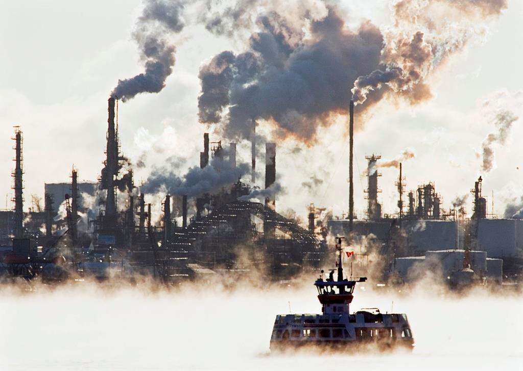 A passenger ferry crosses Halifax harbour through sea smoke in front of Imperial Oil's Dartmouth refinery on Thursday, Jan. 3, 2008.
