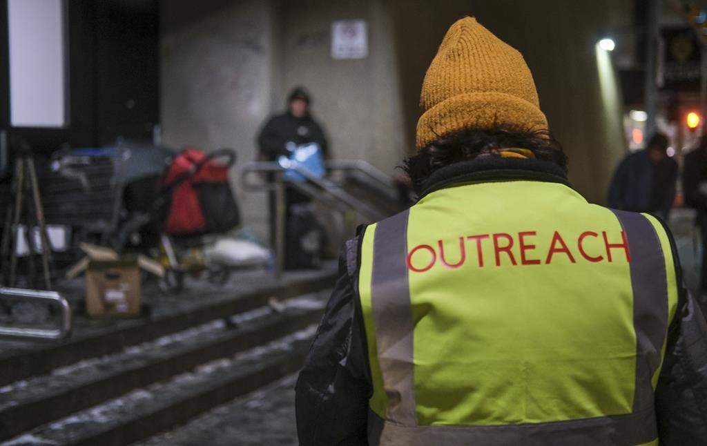 Outreach volunteers offer help to the homeless on a -20 C night in Calgary, Alta., Tuesday, Dec. 14, 2021.