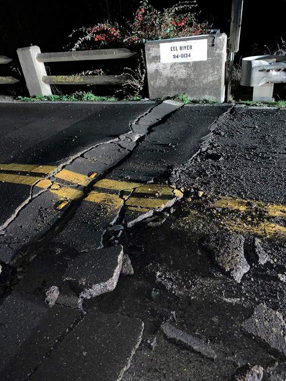 This image posted by Caltrans District 1 shows a road closure on California State Route 211 at Fernbridge, a 1,320-foot-long (402.3 m) concrete arch bridge that spans the Eel River near Fortuna, Calif., in Humboldt County. The bridge is closed while they conduct a safety inspection checking for possible seismic damage. Officials say a strong earthquake in Northern California has cut off power to thousands and damaged roads and homes. No injuries have been reported in the magnitude 6.4 earthquake early Tuesday near Ferndale. That’s a small community over 200 miles northwest of San Francisco and close to the Pacific Coast. (Caltrans District 1 via AP)