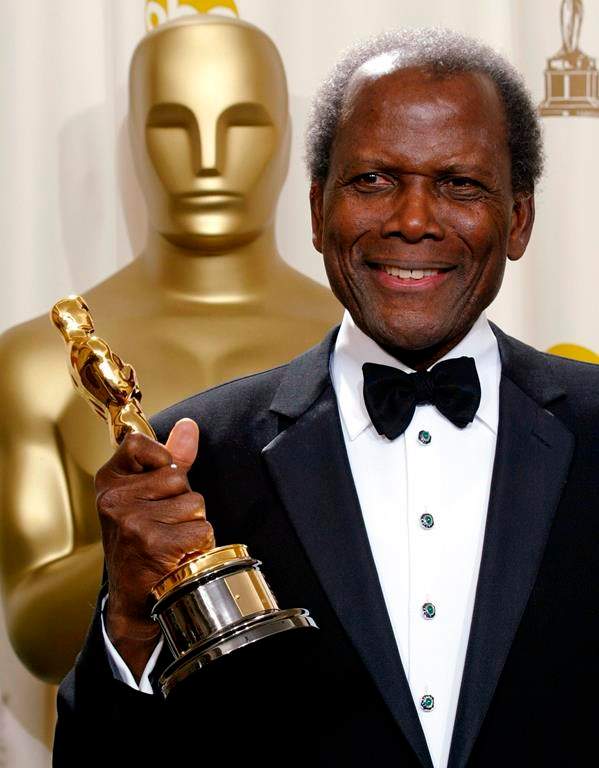 FILE - Sidney Poitier poses with his honorary Oscar during the 74th annual Academy Awards on March 24, 2002, in Los Angeles.