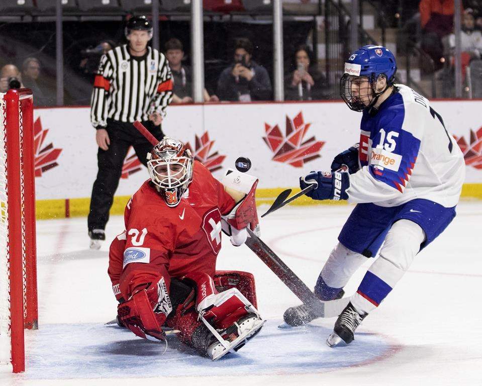 Switzerland’s Kevin Pasche makes a save on Slovakia’s Adam Sykora during shootout IIHF World Junior Hockey Championship hockey action in Moncton, N.B., on Saturday, Dec. 31, 2022.