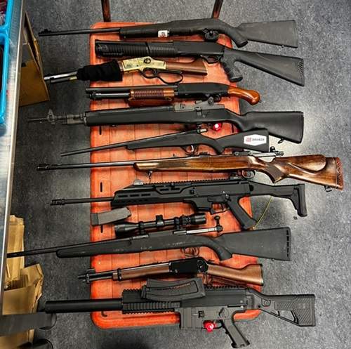 Police found 11 firearms, including a loaded lever action rifle and a loaded 12-gauge shotgun.