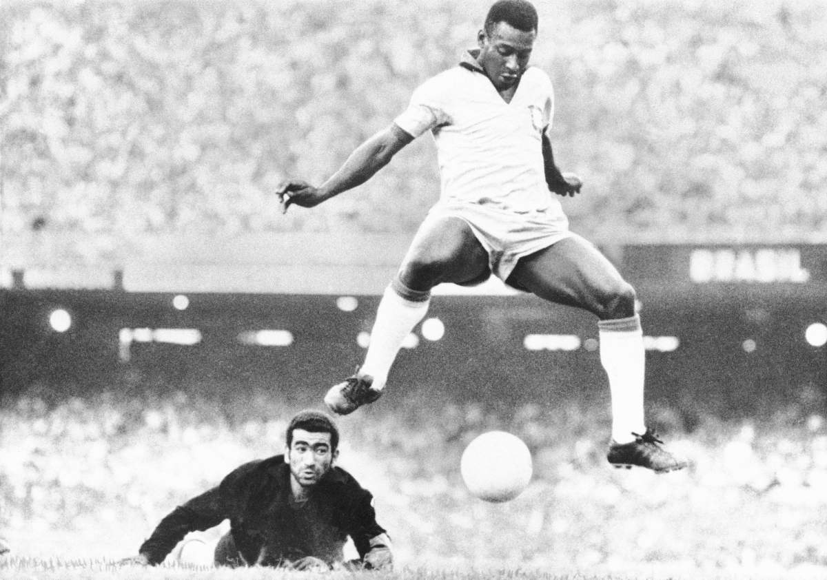FILE – In this Aug. 1969 file photo, Brazil’s Pele scores past Venezuela’s goal keeper Fabrizio Fasano in Rio de Janeiro, Brazil. (AP Photo, File)