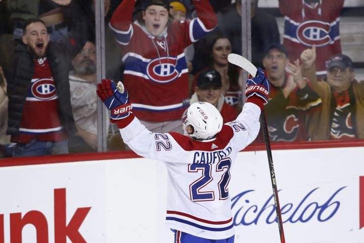 Montreal Canadiens’ Cole Caufield celebrates his game-winning goal against the Calgary Flames with fans, during third period NHL hockey action in Calgary, Thursday, Dec. 1, 2022.