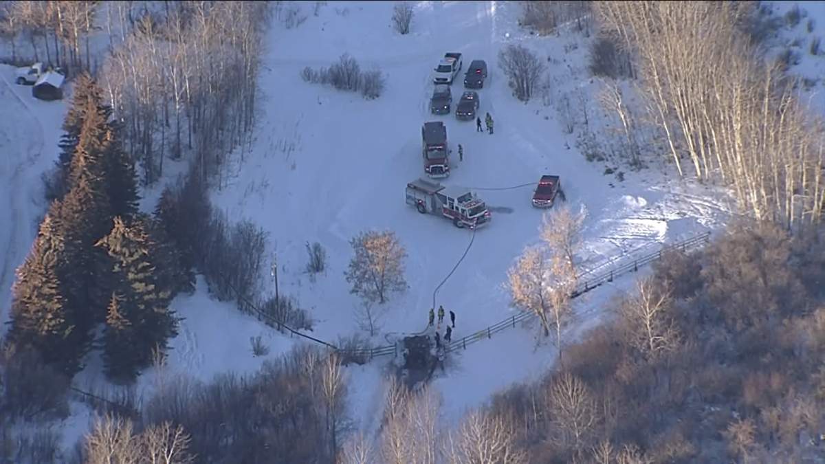Emergency responders attend a burning SUV in Foothills County on Dec. 15, 2022.