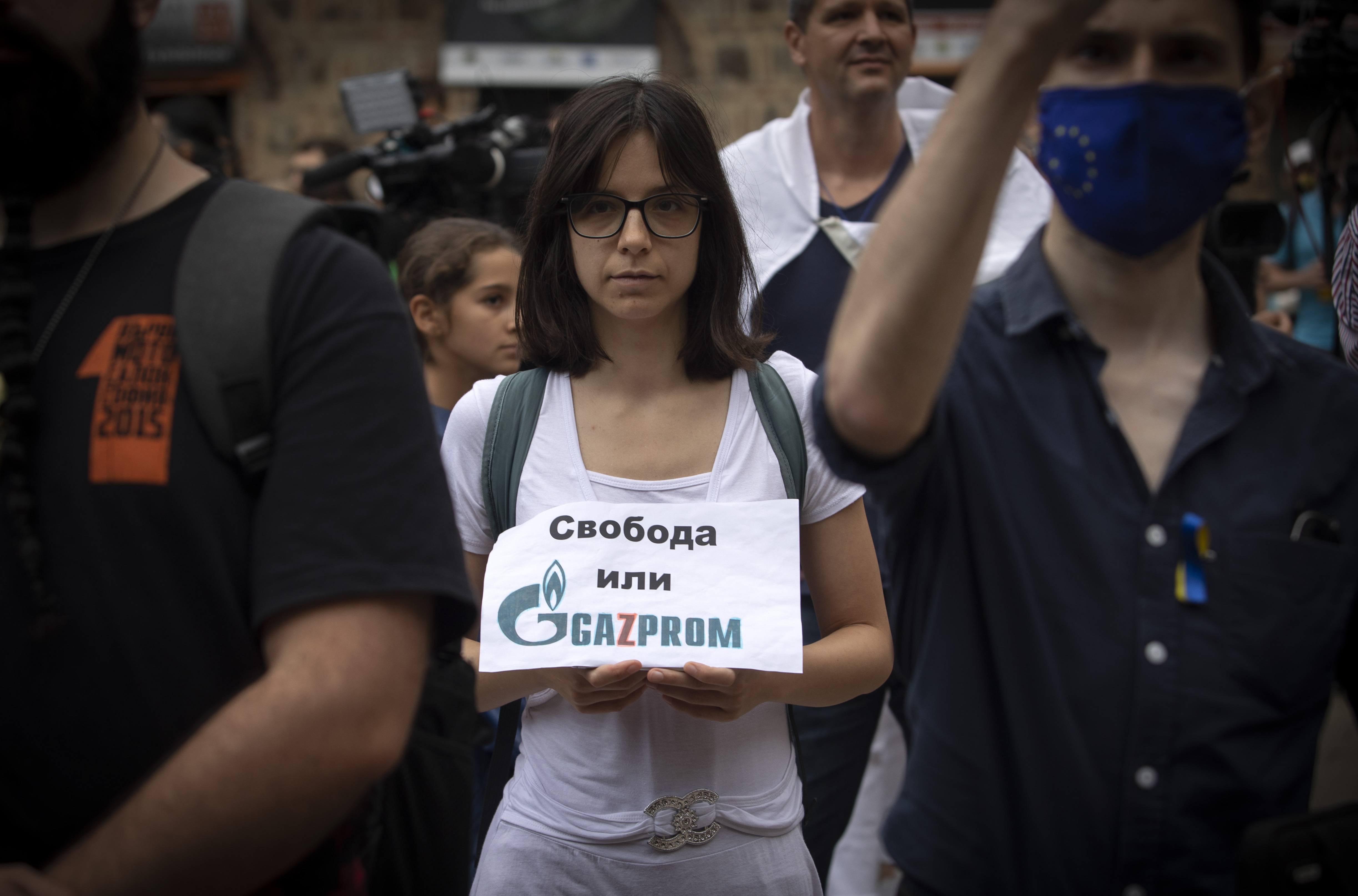 Protester in Bulgarian capital Sofia holds sign reading ‘Freedom or Gazprom’ at rally on Aug 10, 2022. (AP Photo/Valentina Petrova)