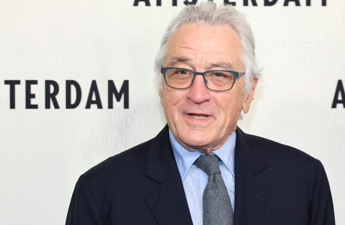Robert De Niro in a black suit and grey tie.