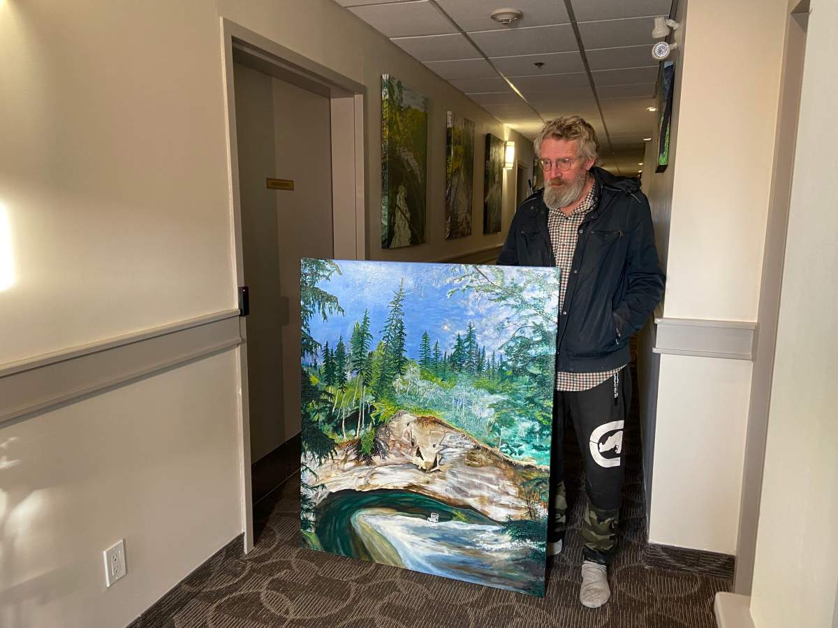 Matthew Dekker, a Prairie Manor resident holds up his artwork, Dec. 20, 2022.