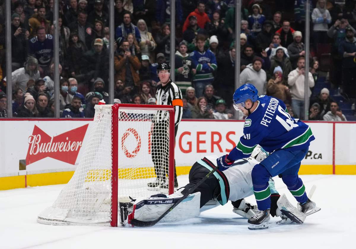 Elias Pettersson of the Vancouver Canucks scores the game-winning goal during NHL action against the Seattle Kraken in Vancouver on Thursday night. The game went to a shootout after Vancouver rallied from a 5-3 deficit to tie the game in the third period.