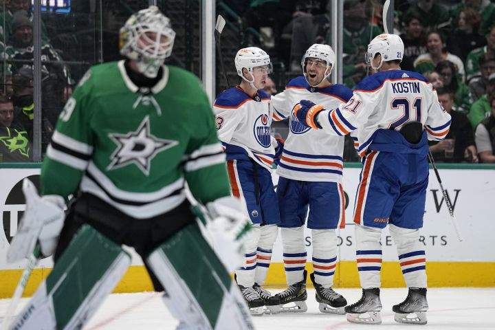 Dallas Stars goaltender Jake Oettinger, left, stands by the net as Edmonton Oilers’ Ryan Nugent-Hopkins, left rear, Evan Bouchard, centre rear, and Klim Kostin celebrate a score by Nugent-Hopkins in the second period of an NHL hockey game, Wednesday, Dec. 21, 2022, in Dallas.