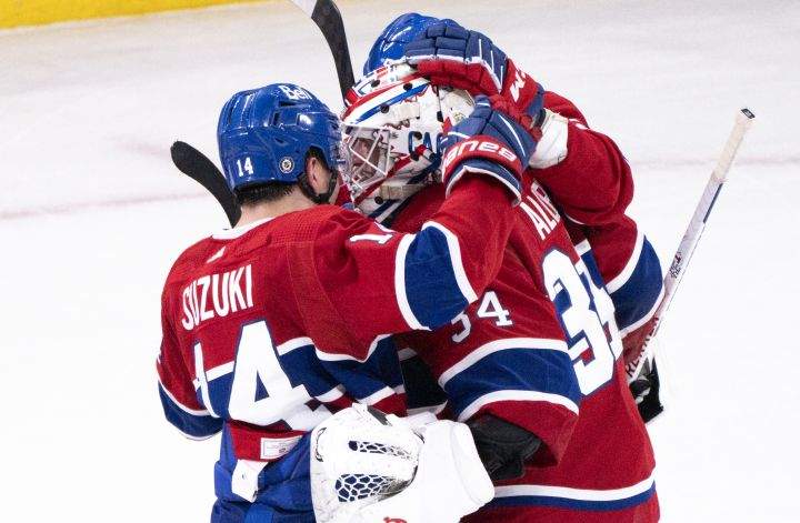 Montreal Canadiens goaltender Jake Allen is congratulated by teammate Nick Suzuki after stopping the Calgary Flames in the shootout to win 2-1 in NHL hockey action in Montreal, Monday, Dec. 12, 2022.
