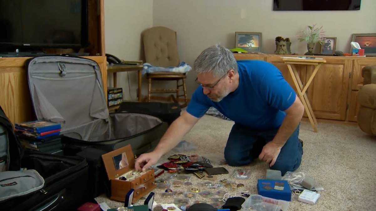 Brian Cole looks over some of the treasured keepsakes that were stolen during a break and enter on Dec. 14, and returned by Calgary police.