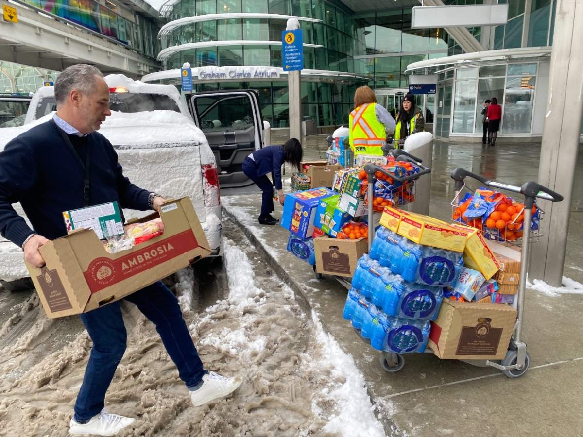 Vancouver airport staff making Costco grocery runs to give food and water to people waiting inside the terminal.
