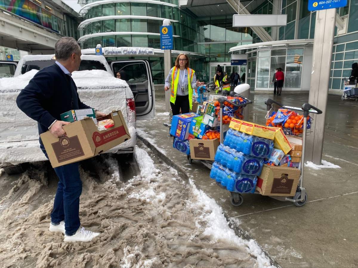 Vancouver airport staff making Costco grocery runs to give food and water to people waiting inside the terminal.