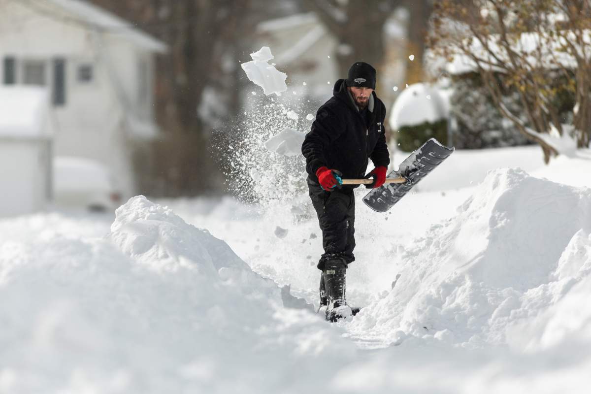 A man shovels a path to his house in Fort Erie, Ont., Saturday, Nov. 19, 2022.