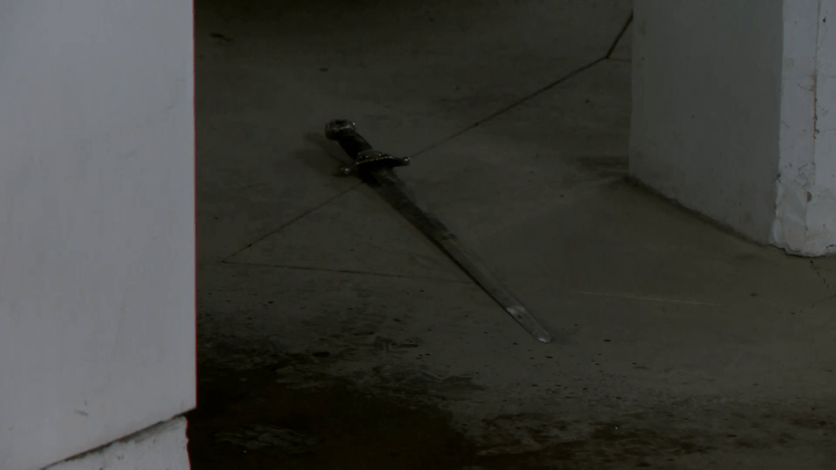 Calgary police say ASIRT is investigating after an officer-involved shooting at a N.W. parkade on Dec. 22, 2022. A Global News videographer observed what appeared to be a sword on the ground behind police tape.