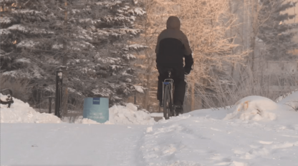A cyclist uses a multi-use path, separated from car traffic, in Edmonton in Jan. 2021.