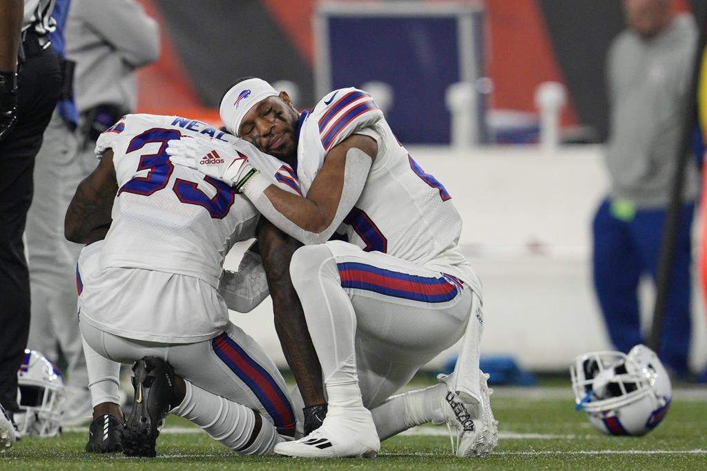 Buffalo Bills’ Siran Neal (33) and Nyheim Hines react after teammate Damar Hamlin was injured during the first half of an NFL football game against the Cincinnati Bengals on Jan. 2 in Cincinnati.