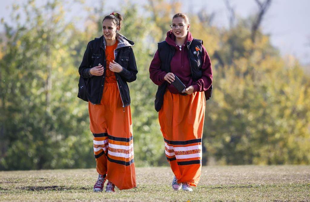 Young women wearing ribbon skirts arrive for National Day for Truth and Reconciliation ceremonies in Calgary on Sept. 30, 2022.