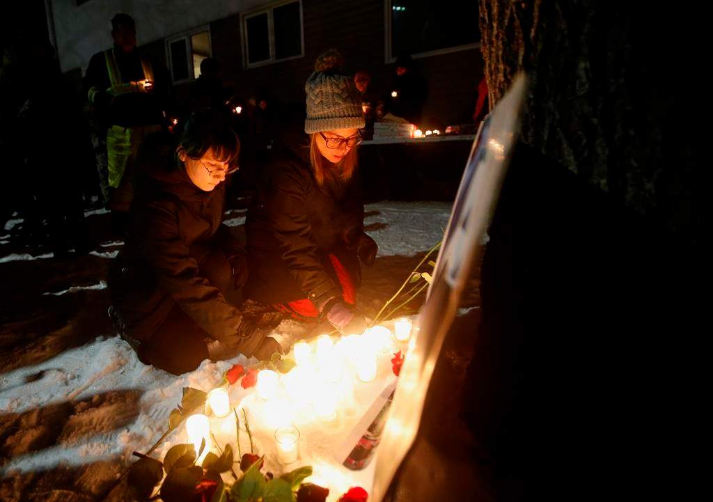 Kirstin Witwicki, right, a cousin of Morgan Harris, joined the family and friends of three slain women at a vigil in Winnipeg, Thursday, Dec. 1, 2022.