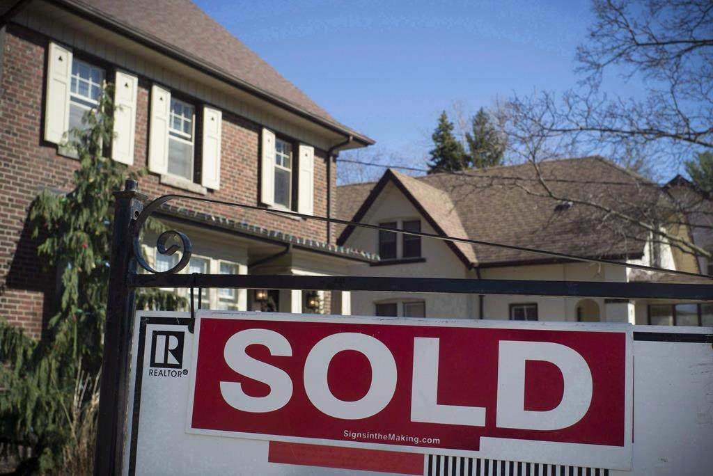 A sold sign is shown in front of west-end Toronto homes, Sunday, April 9, 2017. 