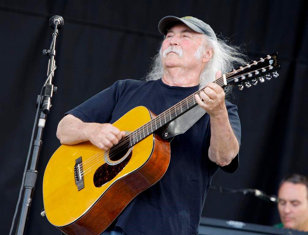 David Crosby holding a guitar.
