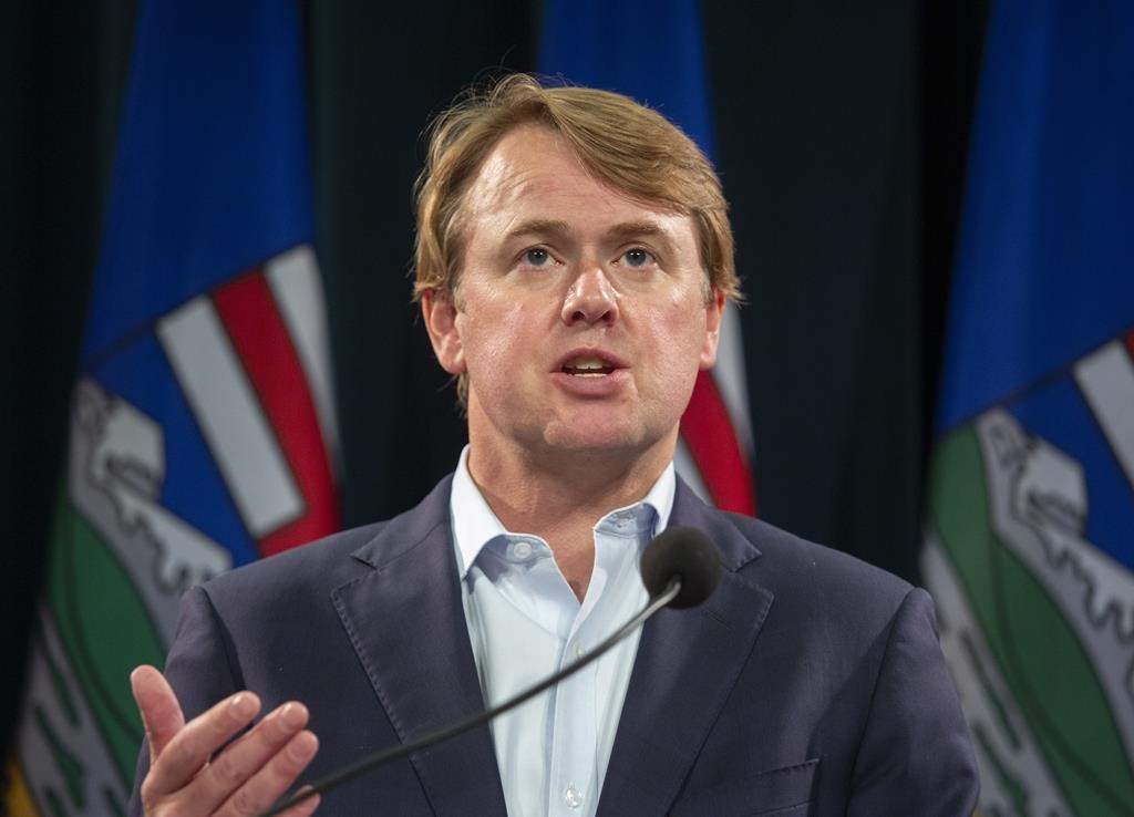 Tyler Shandro answers questions at a news conference in Calgary, Alta., on Sept. 3, 2021. The Alberta government will be restricting municipalities and police from entering into agreements with the federal government for funding to enforce the federal firearms confiscation program. THE CANADIAN PRESS/Todd Korol.