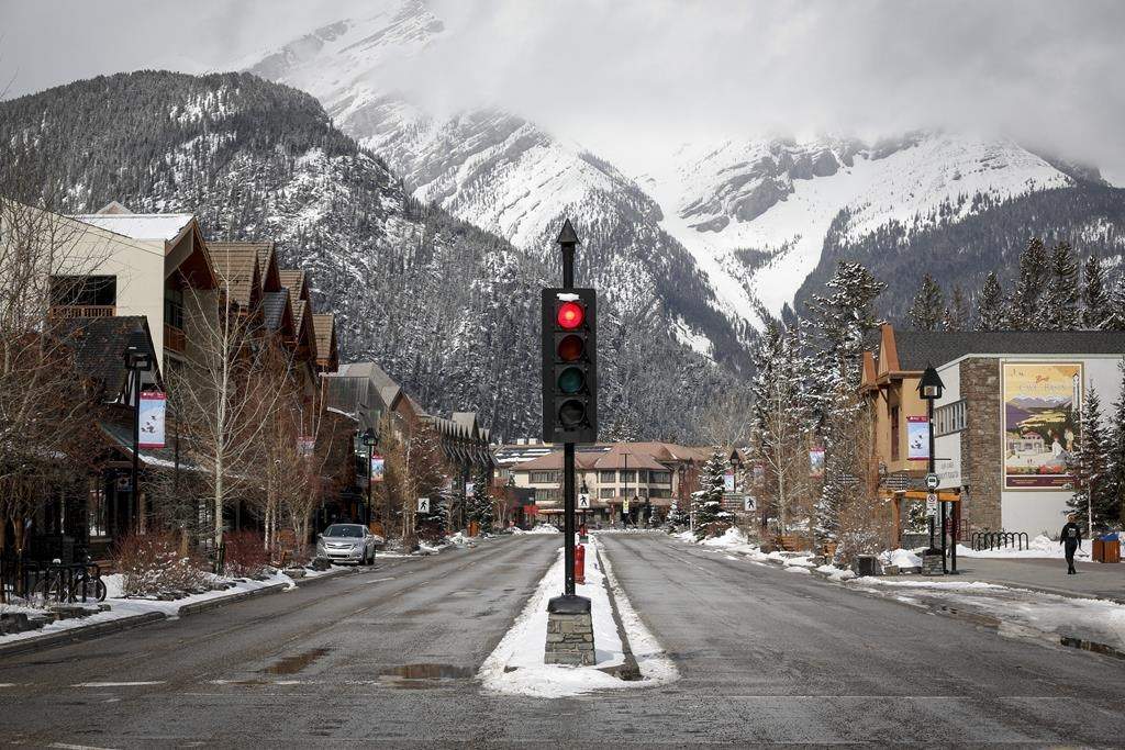 The empty streets of Banff are seen as Parks Canada is restricting vehicles in the national parks and national historic sites in Banff, Alta., on March 24, 2020. Banff tourism officials are joining the call for better management of visitor traffic in the most heavily visited parts of the national park. In a document outlining its development plans for the next decade, Banff and Lake Louise Tourism says it wants to reduce damaging traffic bottlenecks through improved public transit and fewer private vehicles.