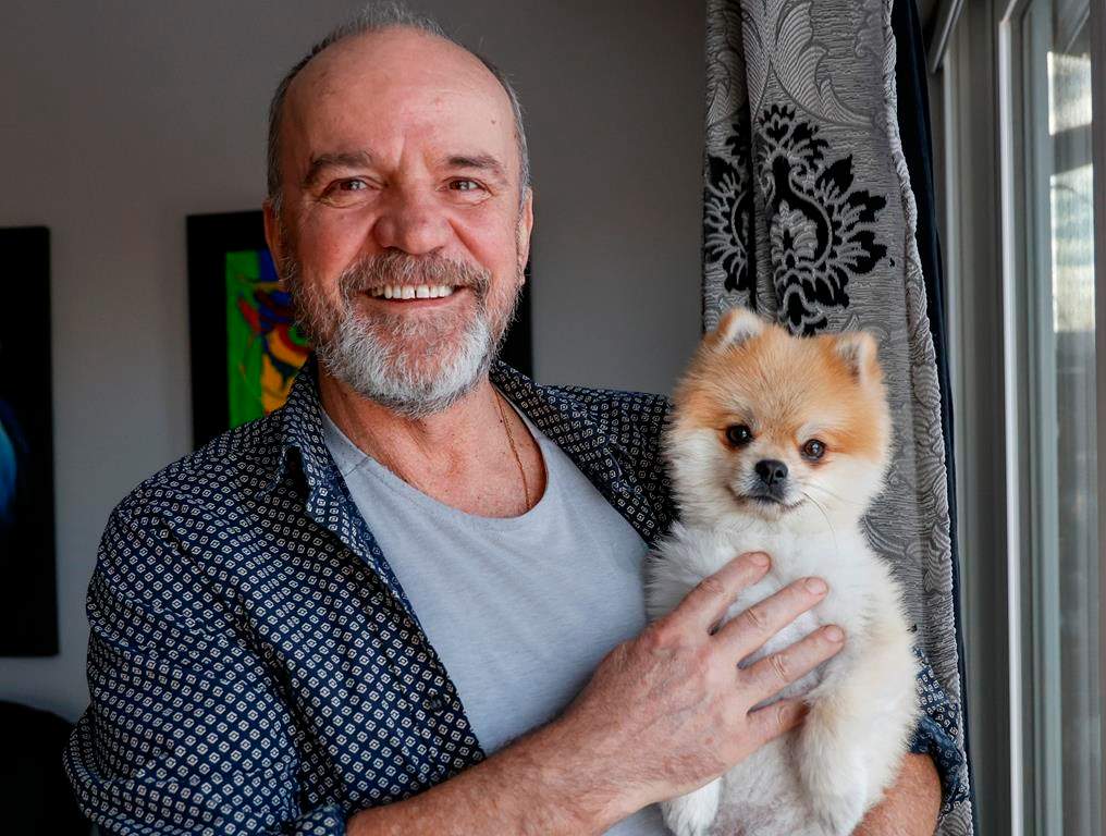 Ivo Ceko holds his dog Charlie at his home in Calgary, Alta., Monday, Jan. 30, 2023.