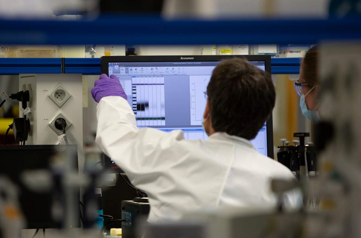 A lab technician looks at a computer screen during clinical trials on a COVID-19 vaccine. McMaster University researchers will benefit from some $131 million in federal funds earmarked to better clinical trials across Canada.